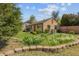 Charming home featuring a well-manicured lawn, mature trees, and inviting landscaping in the front yard at 998 S Leyden St, Denver, CO 80224