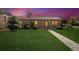 Charming single-story home featuring a well-maintained lawn and inviting walkway to front door at twilight at 998 S Leyden St, Denver, CO 80224