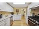 Bright kitchen features white cabinets, stainless steel appliances and lots of counter space at 998 S Leyden St, Denver, CO 80224