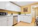 Well-lit kitchen featuring white cabinets, stainless steel appliances, and light bamboo floors at 998 S Leyden St, Denver, CO 80224
