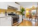 Kitchen view showcasing stainless steel appliances, white countertops, and view into the dining area at 998 S Leyden St, Denver, CO 80224