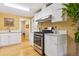Kitchen featuring stainless steel appliances, white cabinets, and light hardwood floors at 998 S Leyden St, Denver, CO 80224