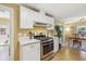 Kitchen view featuring a stainless steel oven and view into dining room at 998 S Leyden St, Denver, CO 80224
