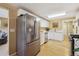 Well-lit kitchen featuring stainless steel appliances, white cabinets, and hardwood floors at 998 S Leyden St, Denver, CO 80224