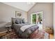 Bedroom featuring vaulted ceiling and sliding glass door to deck at 998 S Leyden St, Denver, CO 80224