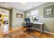 Bright office space with a computer desk, a large window, and a view of the living room at 998 S Leyden St, Denver, CO 80224