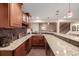 Well-equipped basement bar with granite countertop and cabinetry at 1429 S Grand Baker Cir, Aurora, CO 80018