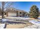 House exterior featuring stone facade, two-car garage, and landscaping at 1429 S Grand Baker Cir, Aurora, CO 80018