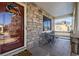 Front porch with stonework, seating area, and solar panels visible at 1429 S Grand Baker Cir, Aurora, CO 80018