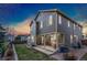 Enjoy outdoor living on the patio of this two-story home; also features a well-maintained lawn at 1831 Ashford Cir, Longmont, CO 80504