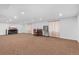 Expansive carpeted basement space with recessed lighting, and a dining area at 1831 Ashford Cir, Longmont, CO 80504