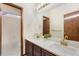 Bathroom featuring double sinks, new countertops, gold hardware, and a bright white shower/tub at 1831 Ashford Cir, Longmont, CO 80504
