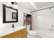 Bright bathroom featuring a modern vanity, framed mirror, bathtub, shower and useful shelving at 1831 Ashford Cir, Longmont, CO 80504