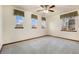 Bedroom with neutral walls, carpet, natural trim, and three windows at 1831 Ashford Cir, Longmont, CO 80504