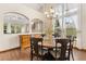 Dining room features a rustic table set, hardwood floors, and abundant natural light at 1831 Ashford Cir, Longmont, CO 80504