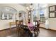 Elegant dining room featuring a wooden table, chandelier, and large windows, creating a welcoming atmosphere at 1831 Ashford Cir, Longmont, CO 80504