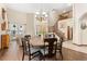 Open-concept dining area next to staircase with hardwood floors and natural light at 1831 Ashford Cir, Longmont, CO 80504
