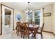 The dining room features a classic wood table, seating for six, and lots of natural light at 1831 Ashford Cir, Longmont, CO 80504
