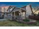 Charming two-story home with a covered front porch and well-maintained front yard and a two car garage at 1831 Ashford Cir, Longmont, CO 80504