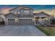 Spacious two-story home featuring a three-car garage and inviting covered porch, perfect for Gathering living at 1831 Ashford Cir, Longmont, CO 80504
