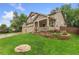Well-manicured lawn and beautiful flower beds add to the curb appeal of this delightful home at 1831 Ashford Cir, Longmont, CO 80504
