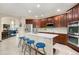Kitchen featuring an island, stainless steel appliances, and adjacent living spaces at 1831 Ashford Cir, Longmont, CO 80504