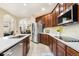 Bright kitchen featuring an island with a sink, modern appliances, and sleek countertops at 1831 Ashford Cir, Longmont, CO 80504