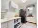 Laundry room with a sink, storage, and stacked washer and dryer at 1831 Ashford Cir, Longmont, CO 80504
