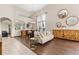 Bright and airy living room with hardwood floors, neutral tones, and decorative mirrors at 1831 Ashford Cir, Longmont, CO 80504