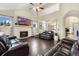 Cozy living room featuring a fireplace, hardwood floors, and open access to the adjacent dining area at 1831 Ashford Cir, Longmont, CO 80504
