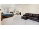 Large bedroom with a seating area, comfy brown sofa, neutral carpet and ample natural light at 1831 Ashford Cir, Longmont, CO 80504