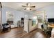 Home office with natural light, wood-look floors, a ceiling fan, and a modern cubicle workstation at 1831 Ashford Cir, Longmont, CO 80504