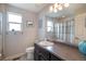 Bathroom featuring a sleek vanity, neutral walls, and a framed mirror at 17996 E 54Th Ave, Denver, CO 80249