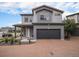 Inviting two-story home with a brick driveway, an attached garage and manicured landscaping at 17996 E 54Th Ave, Denver, CO 80249