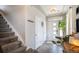 Bright foyer with tile floors, stairs, a coat rack and a plant bringing the outside, in at 17996 E 54Th Ave, Denver, CO 80249