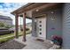 Covered front porch with decorative columns, stylish lighting, and a welcoming entrance at 17996 E 54Th Ave, Denver, CO 80249