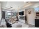 Spacious living room featuring a fireplace, comfortable seating, and a large window at 17996 E 54Th Ave, Denver, CO 80249