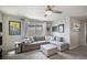 Cozy living room with a comfortable gray sectional sofa, decorative pillows, and lots of natural light at 17996 E 54Th Ave, Denver, CO 80249