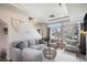 Bright living room with large windows, neutral colors, comfortable seating, and stylish decor at 17996 E 54Th Ave, Denver, CO 80249