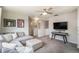 Upstairs loft area with a large sectional, flat-screen television, and neutral decor at 17996 E 54Th Ave, Denver, CO 80249