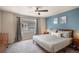 Serene main bedroom features a large window, natural light, and a calming blue accent wall at 17996 E 54Th Ave, Denver, CO 80249