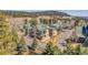 Scenic mountain neighborhood featuring townhomes with mature trees and convenient garages at 1294 Red Lodge Dr, Evergreen, CO 80439