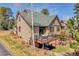 Back exterior featuring a small deck and a grassy area at 1294 Red Lodge Dr, Evergreen, CO 80439