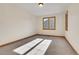 Sunlit bedroom with neutral walls, trim, and carpet, with light pouring in from the large windows at 1294 Red Lodge Dr, Evergreen, CO 80439
