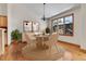Bright dining room with modern chandelier, round table, and large window at 1294 Red Lodge Dr, Evergreen, CO 80439