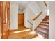 Inviting foyer with hardwood floors, staircase, and natural light at 1294 Red Lodge Dr, Evergreen, CO 80439