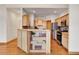 Kitchen with wood cabinets and an island with shelving for added storage and decor at 1294 Red Lodge Dr, Evergreen, CO 80439
