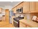 Kitchen featuring wooden cabinets, stainless steel appliances, and tile backsplash at 1294 Red Lodge Dr, Evergreen, CO 80439