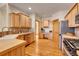 Bright kitchen with wood cabinets, stainless steel appliances, and a functional desk area at 1294 Red Lodge Dr, Evergreen, CO 80439