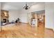Expansive living room with a stone fireplace, hardwood floors, and an open layout to the kitchen at 1294 Red Lodge Dr, Evergreen, CO 80439